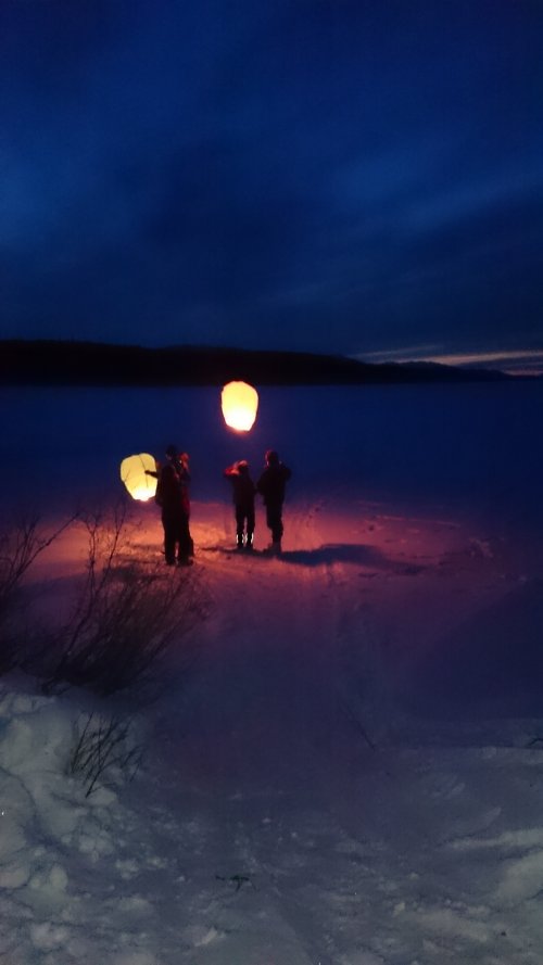 Chinese lanterns released from frozen lake